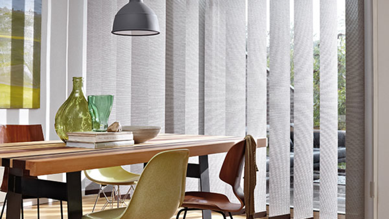 Large silver blinds in large room with laminated flooring