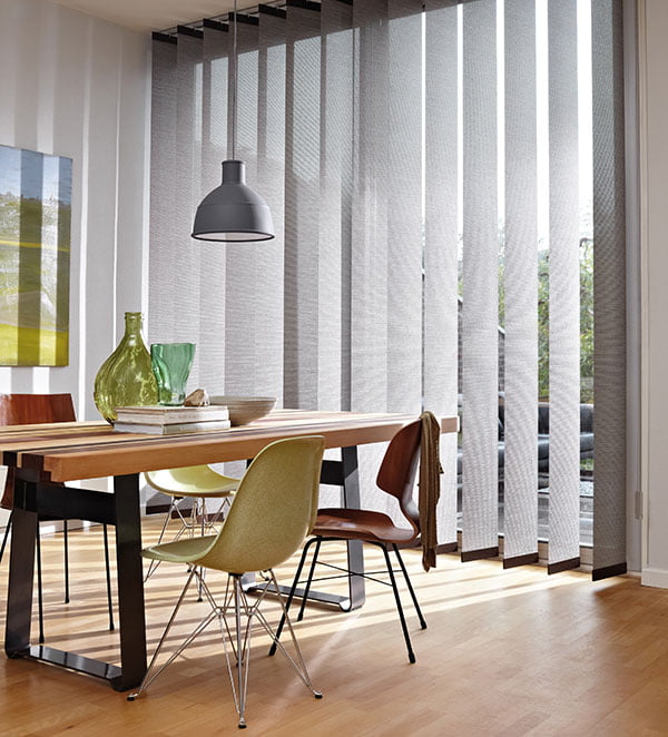 Vertical Blinds - Paul James Blinds Large silver blinds in large room with laminated flooring