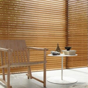 Wooden Table in Front of Wooden Blinds